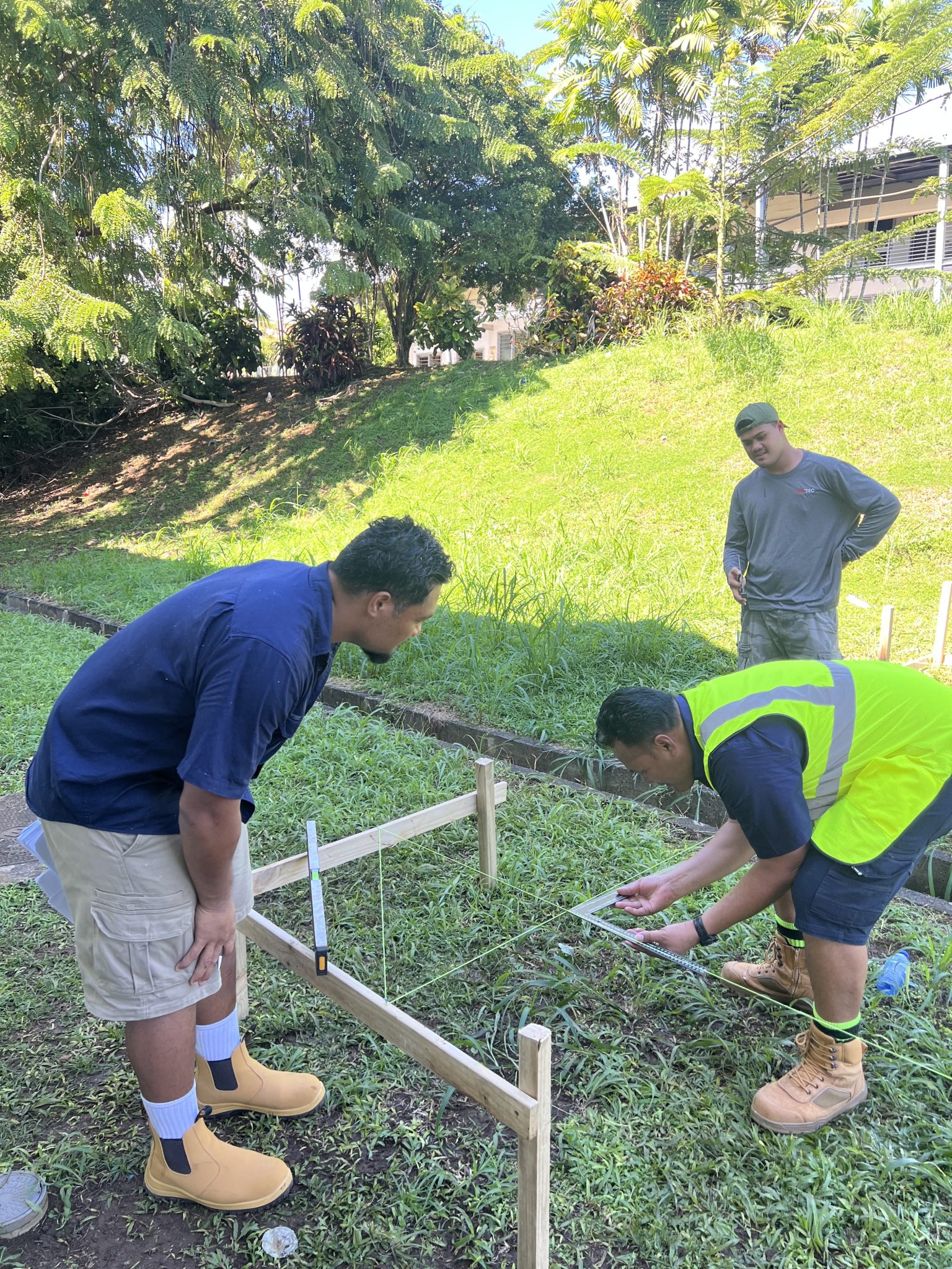 Participants marking out timber during the practical evaluation.