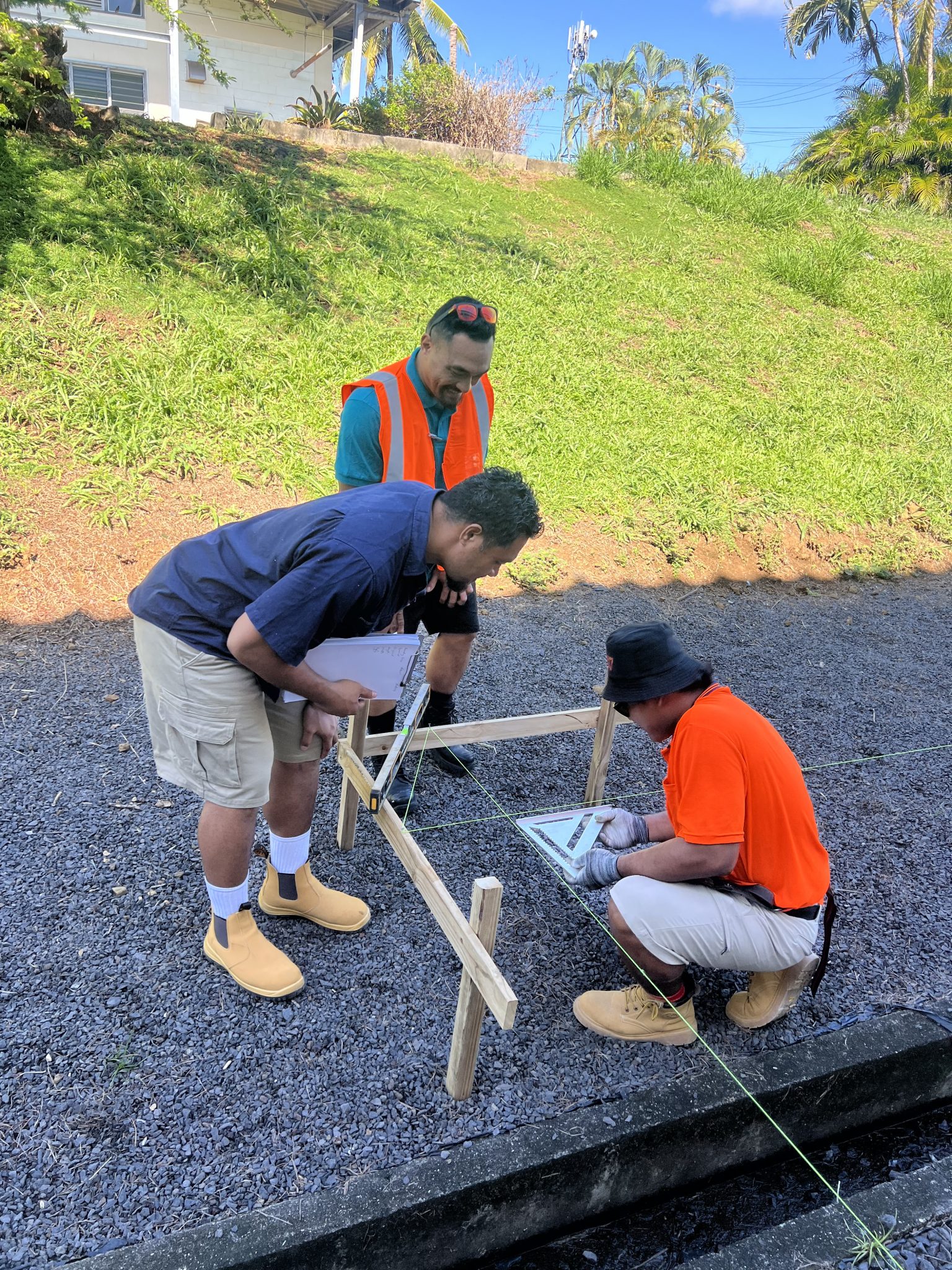 Candidates assembling a timber frame on the workshop grounds.