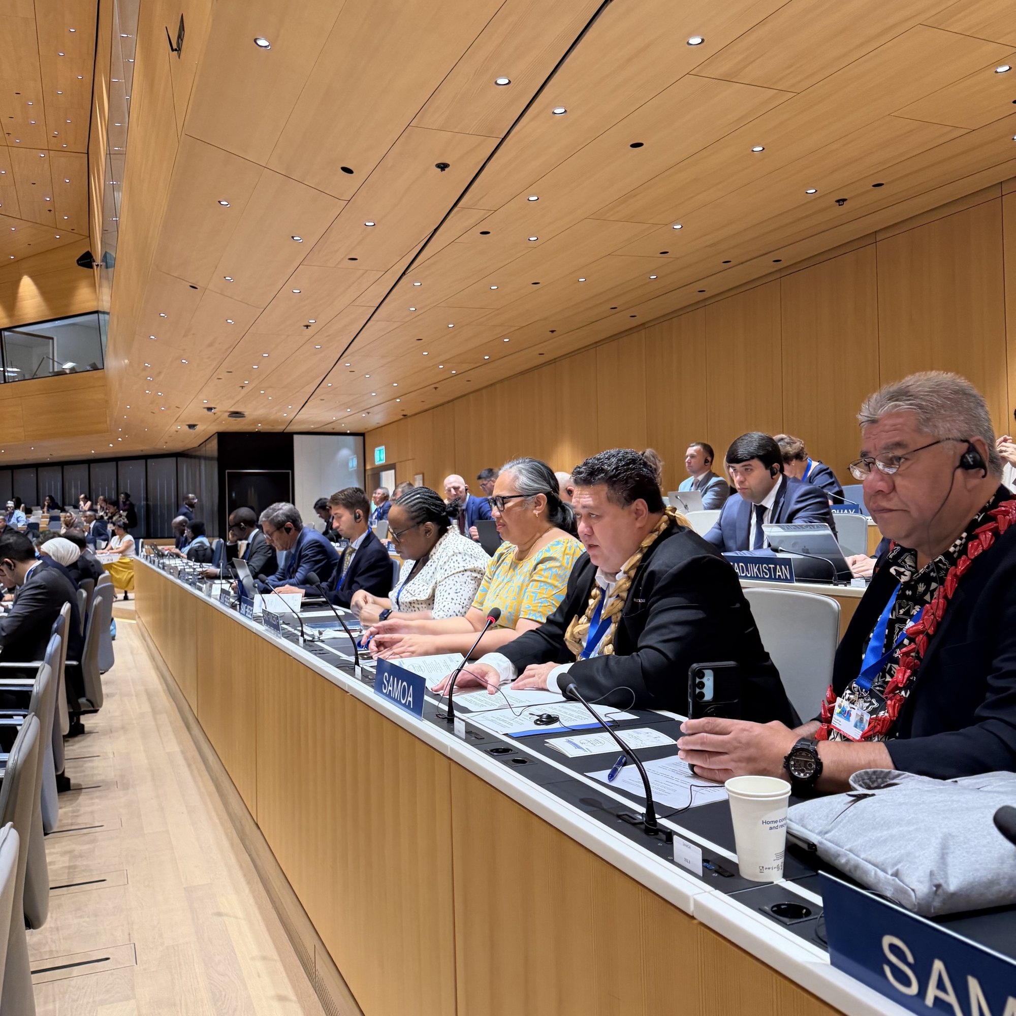 Members of Samoa's delegation seated in a row at the Samoa desk in the WIPO assembly hall in Geneva.