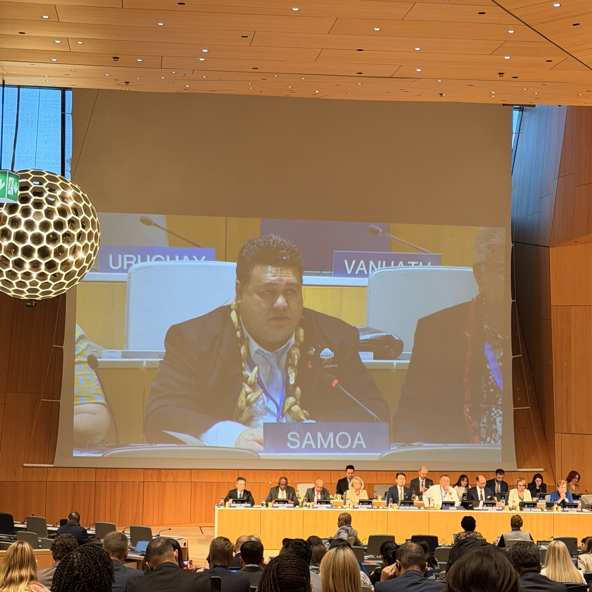 Minister Fata Ryan Schuster delivers the Pacific Statement at the WIPO General Assemblies plenary shown on the hall's large screen in Geneva.