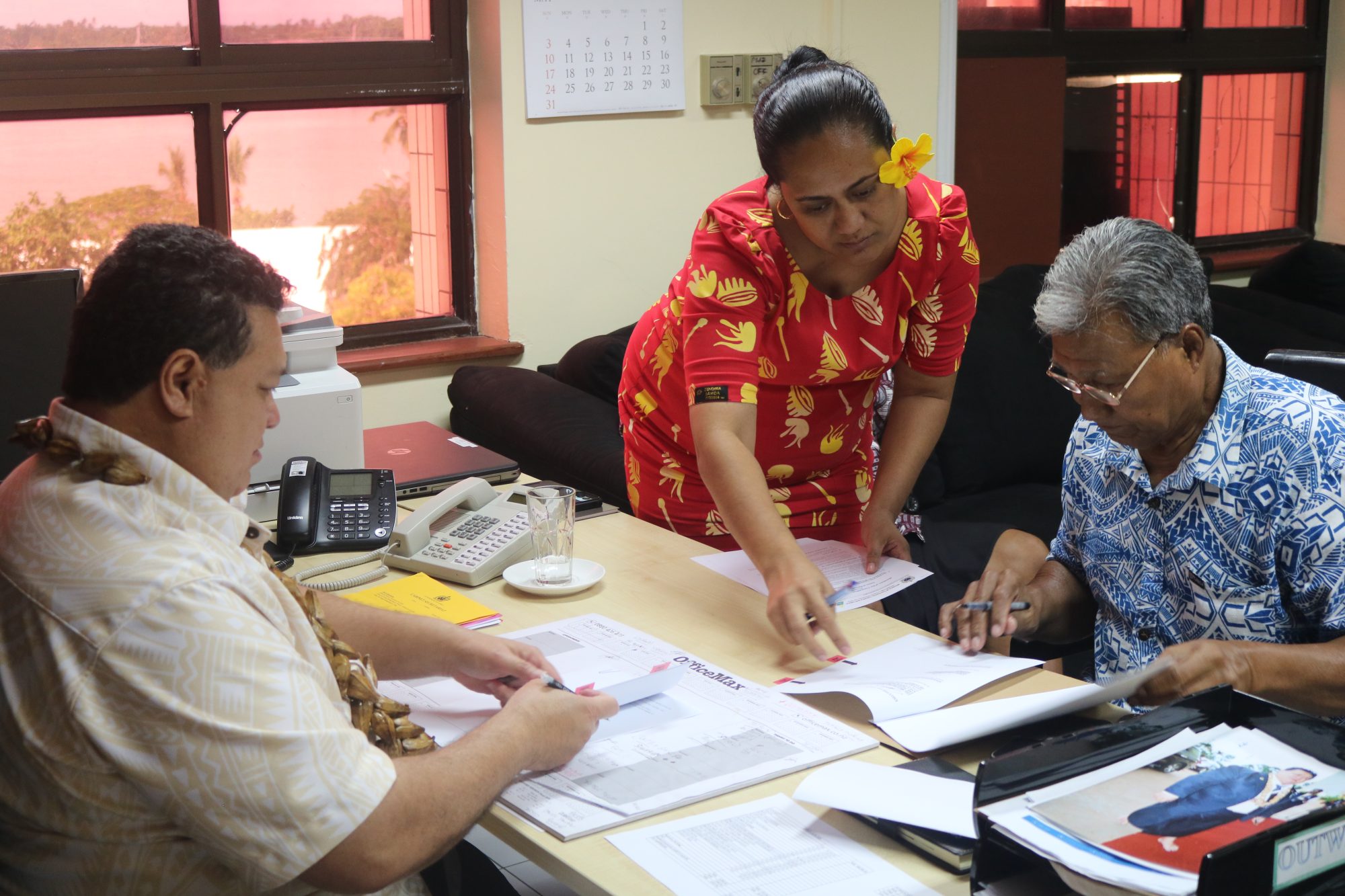 A ministry officer assisting the new Commissioners with their contracts.